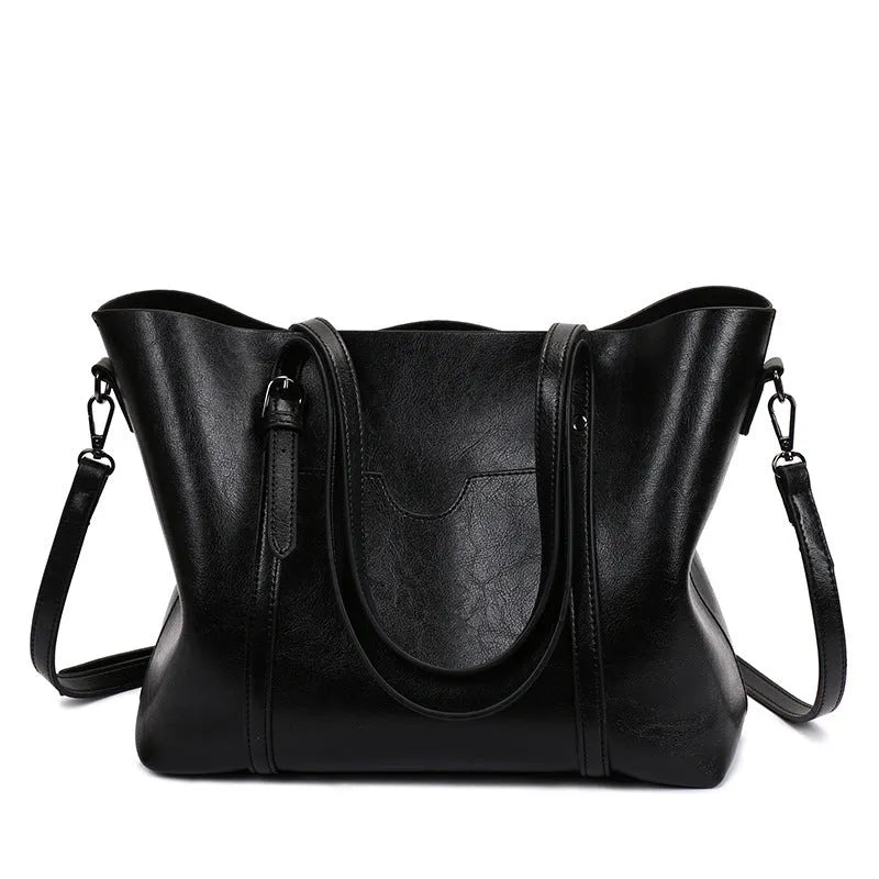 Retro-style brown PU messenger bag for women shown with shoulder strap, displaying its large main compartment.