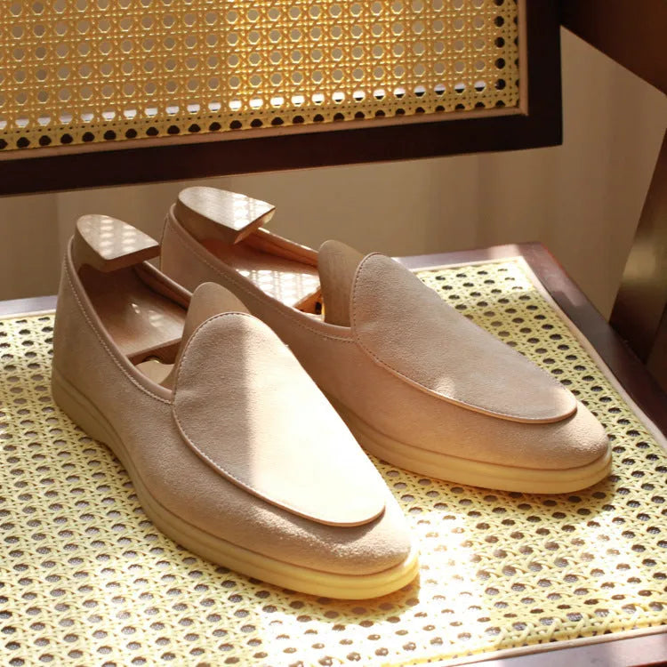 Men's brown genuine leather flat loafers with a low cut and TPR sole on a light background.