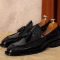 Men's black genuine leather slip-on loafers with a polished finish and rubber sole