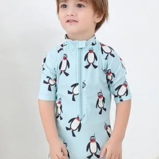 Blue boys two-piece penguin swimsuit with long sleeves and a matching swim cap.