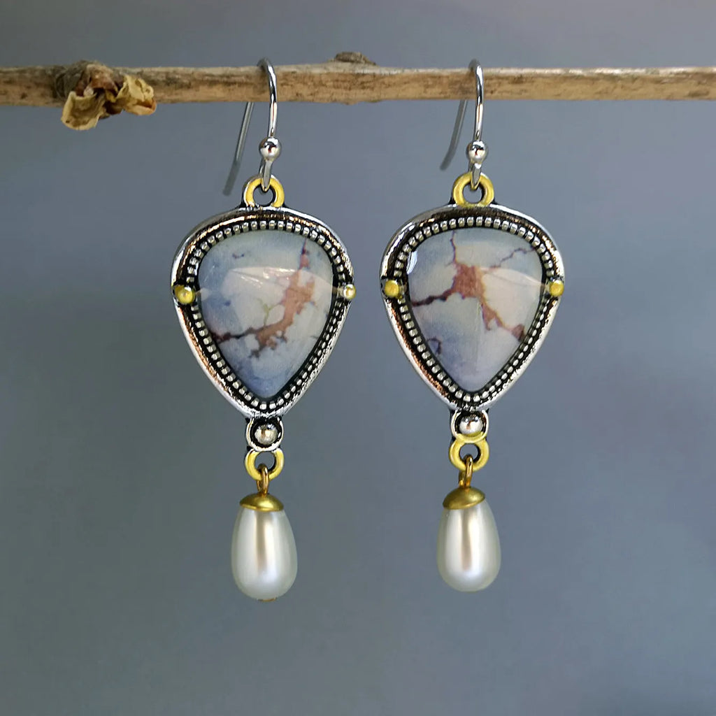 Retro blue geometric drop earrings with synthetic opal and pearl details on a two-tone electroplated metal setting.