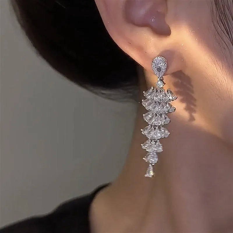 Silver pagoda Christmas tree drop earrings with sparkling zircon crystals on copper studs.