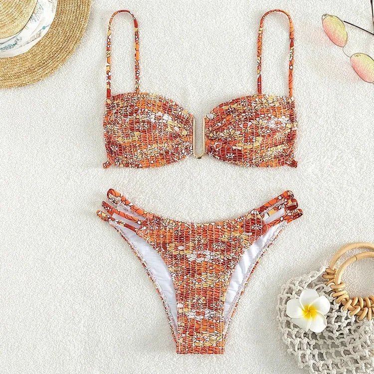 Women's high-waist floral bikini swimsuit on a hanger in blue, orange, pink, and rose red colours.