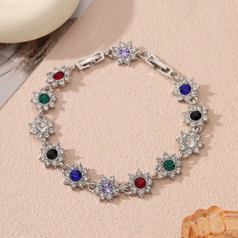 Electroplated zinc alloy flower bracelet in a choice of gold or silver finishes with coloured gemstone designs.