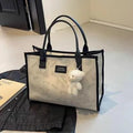 Women's black and white canvas tote bag with rhombus pattern and horizontal square shape