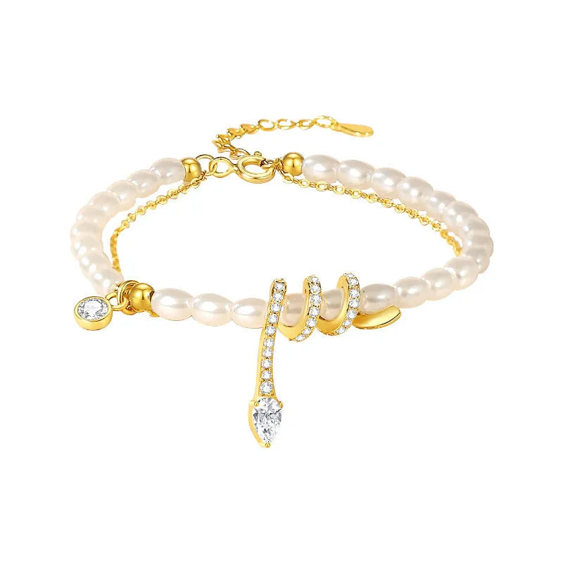Pearl snake bracelet in 925 silver with electroplated gold or white gold colour on a wrist.