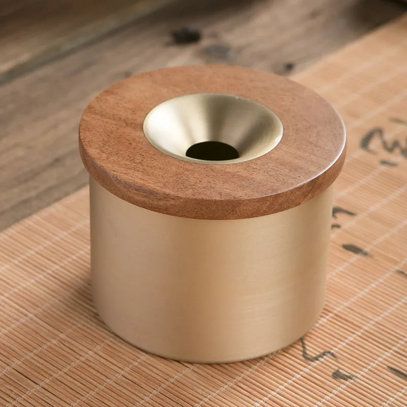 Brass ashtray with wooden lid in copper construction showing centre hole design