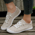 Women's creamy white low-top fabric sneakers with rubber soles on various surfaces