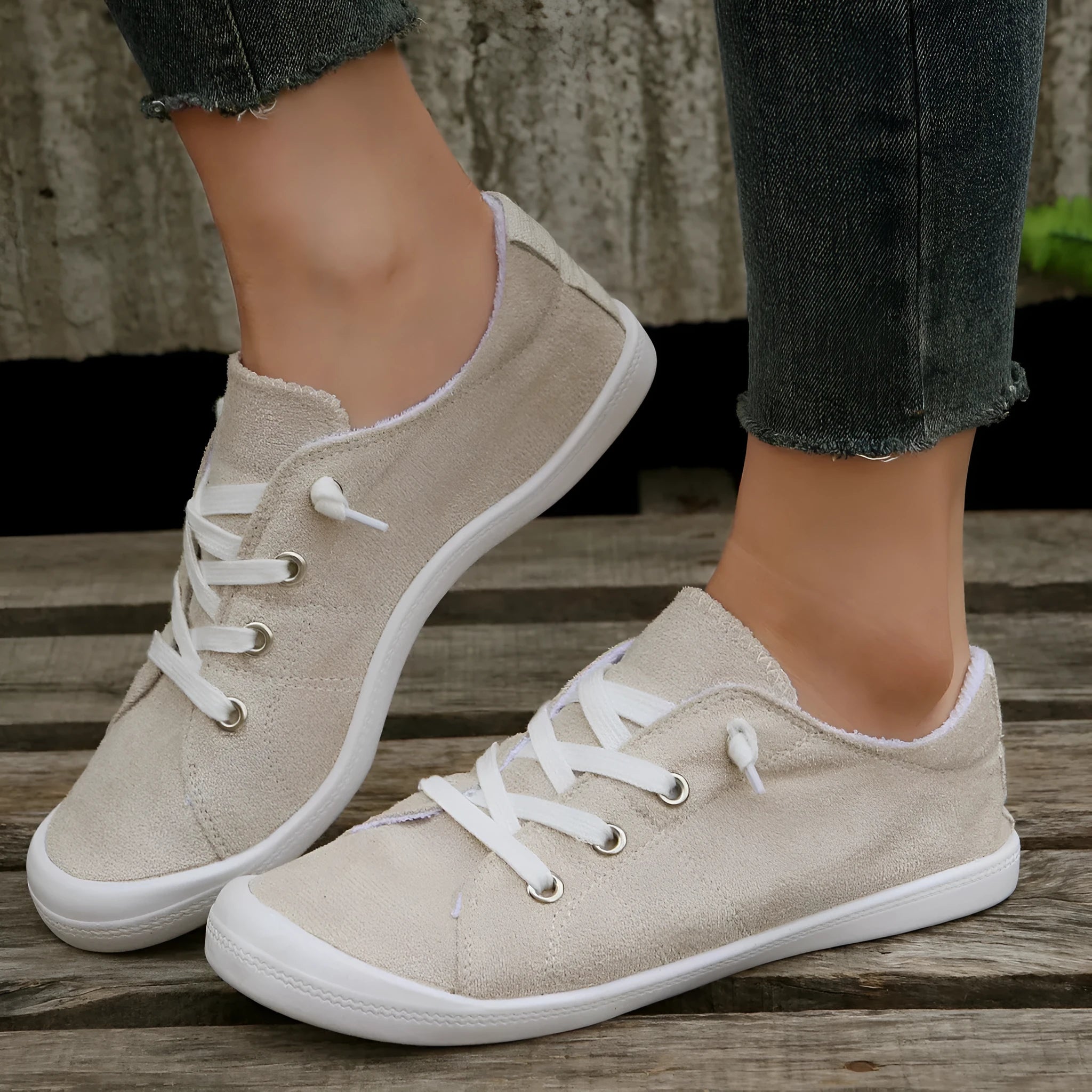 Women's creamy white low-top fabric sneakers with rubber soles on various surfaces