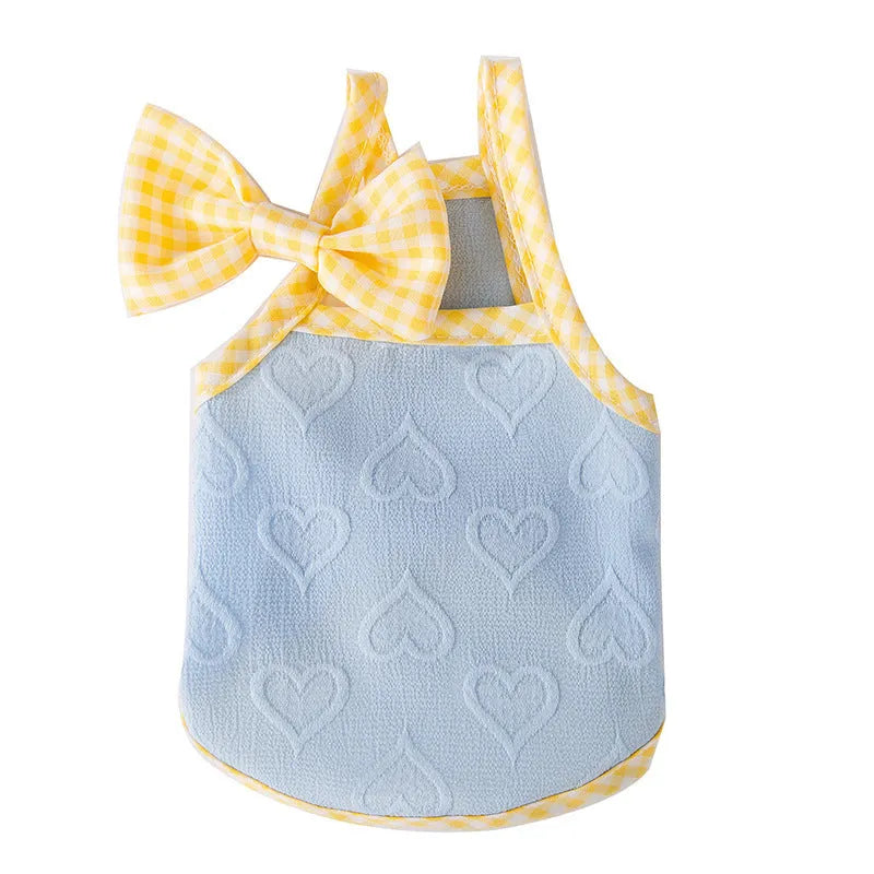 Small dog wearing heart bow suspenders vest in blue with elastic sides