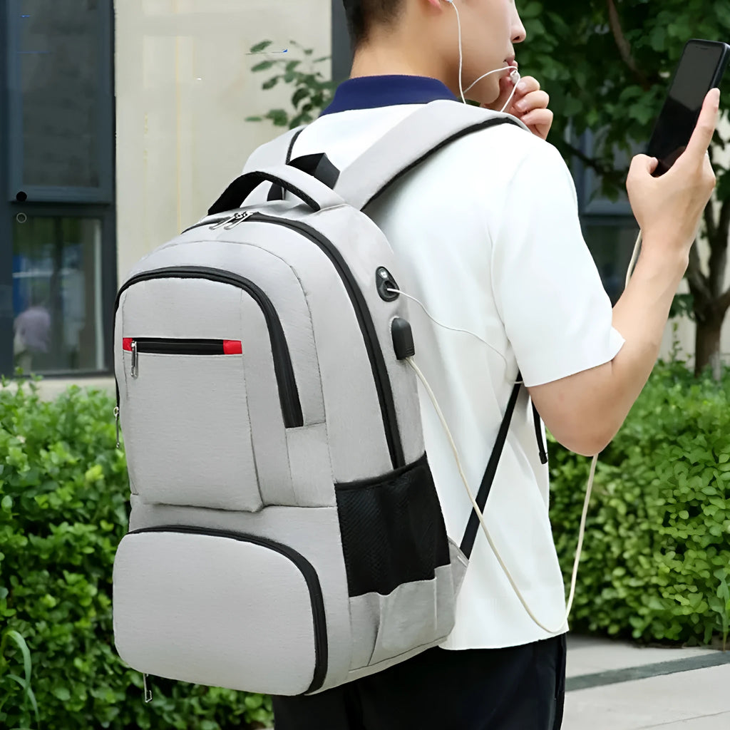 Light grey oxford cloth insulated backpack with curved shoulder straps and top handle.