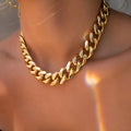 Women's thick chain necklace in dense gold colour measuring 32cm length with simple solid colour design
