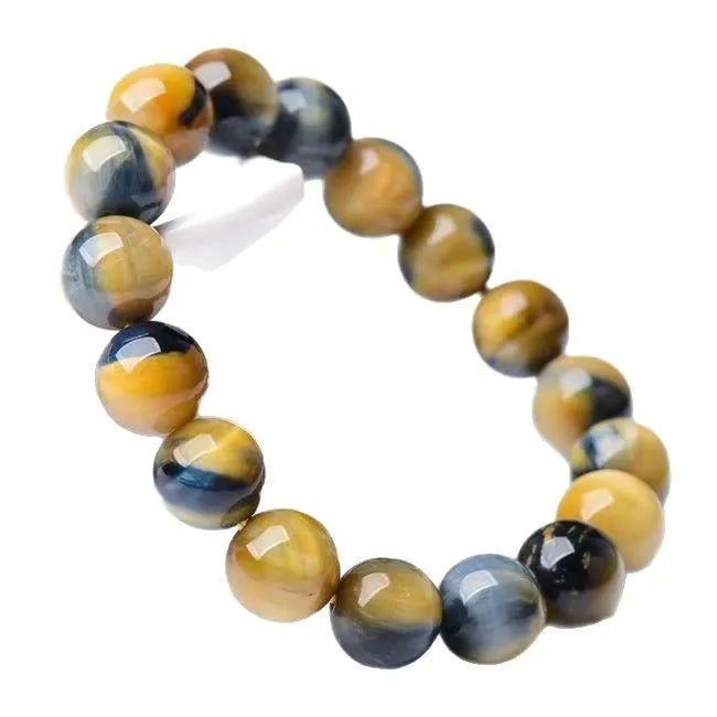 Fantasy tiger eye agate stone bracelet with round beads in geometric pattern on wrist.