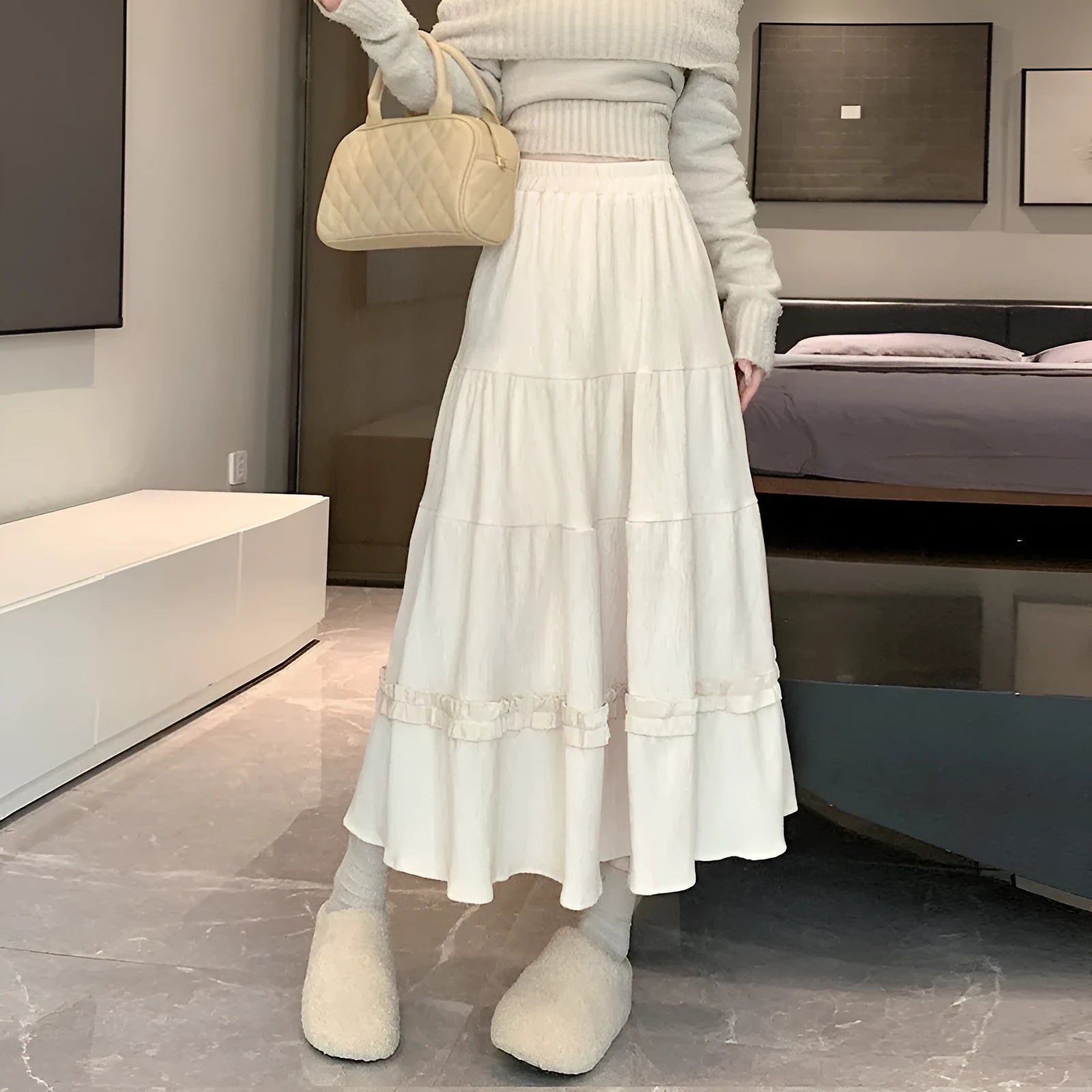 Women's beige corduroy A-line midi skirt with elastic waistband laid flat