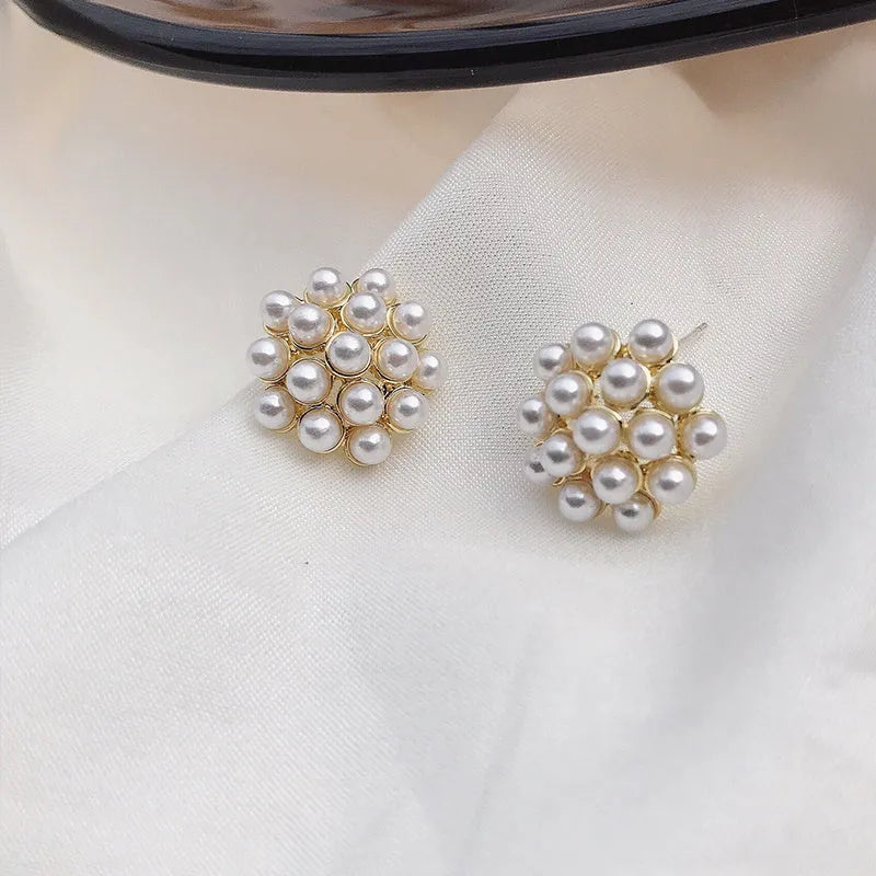 Korean style gold pineapple starfish pearl earrings made from electroplated alloy with inlaid stones.