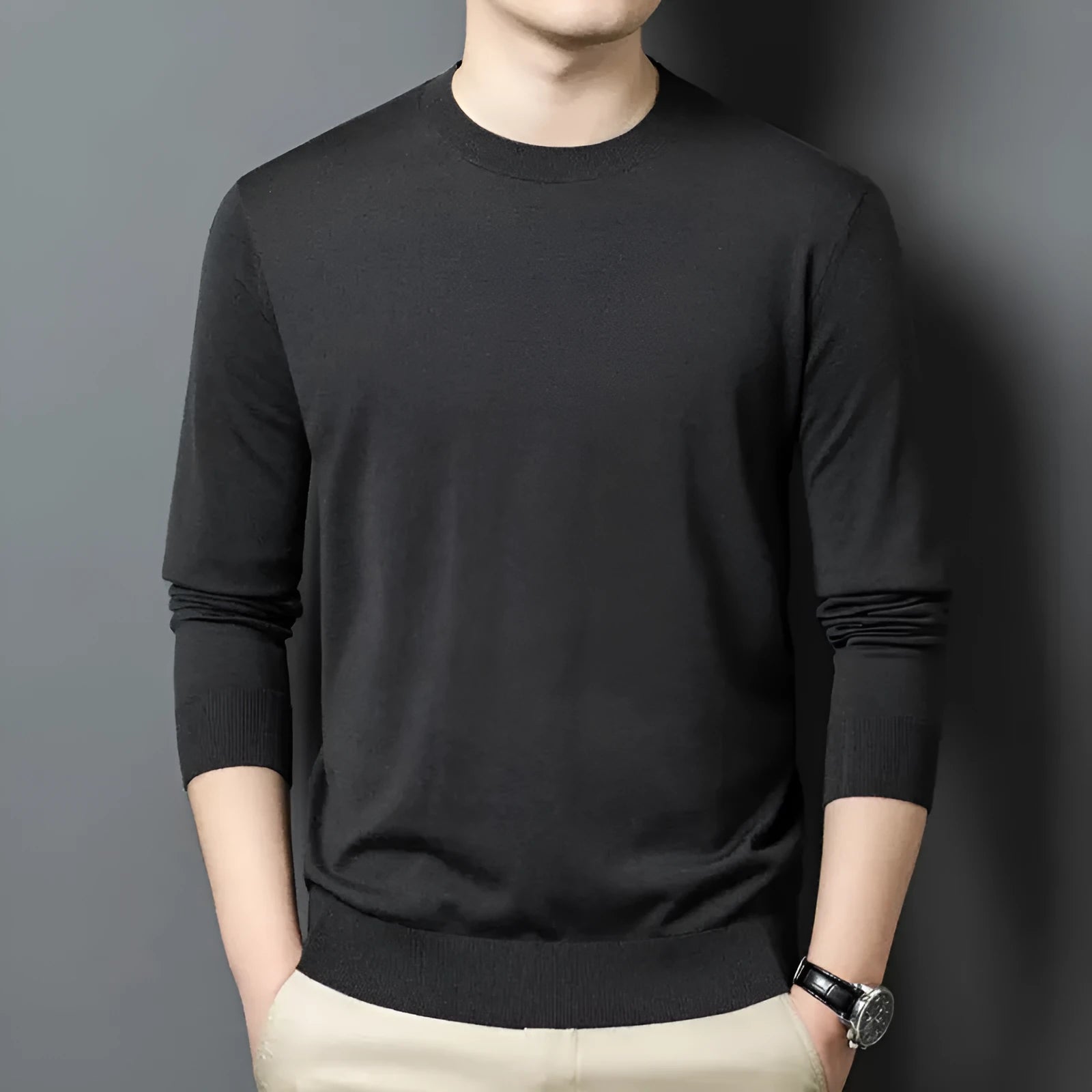 Men's round neck wool pullover sweater in a neutral colour with long sleeves, laid flat.