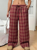 Women's loose fit plaid trousers with drawstring waist and side pockets in red and blue colours