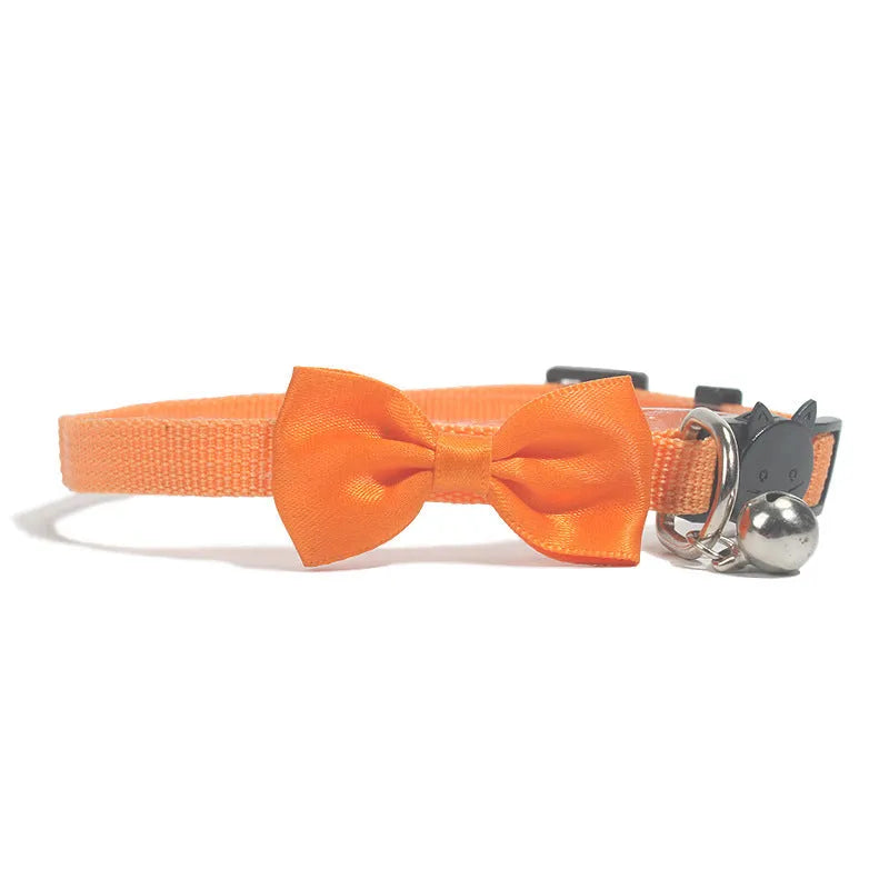 Adjustable nylon cat collar with decorative bow and bell in multiple colour options including red, blue, pink and green