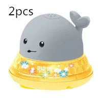 White and blue whale-shaped electric bath toy with water spray fountain and LED lights