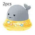 White and blue whale-shaped electric bath toy with water spray fountain and LED lights
