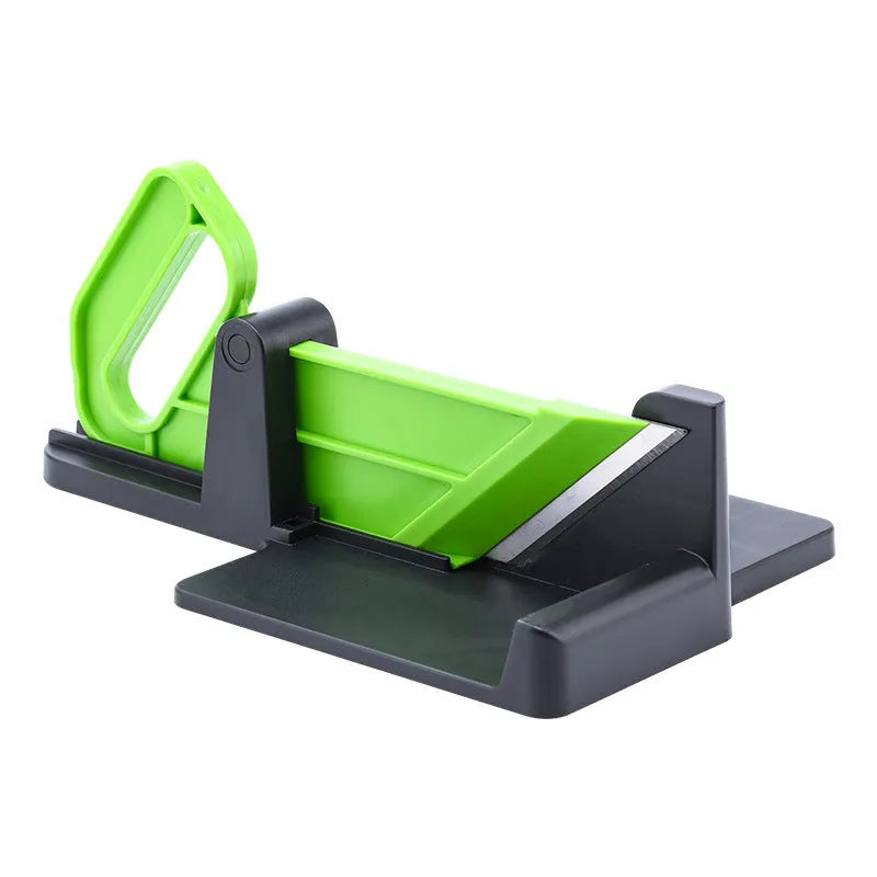 Green and red modern vegetable cutting tool for carrots and potatoes on a kitchen counter