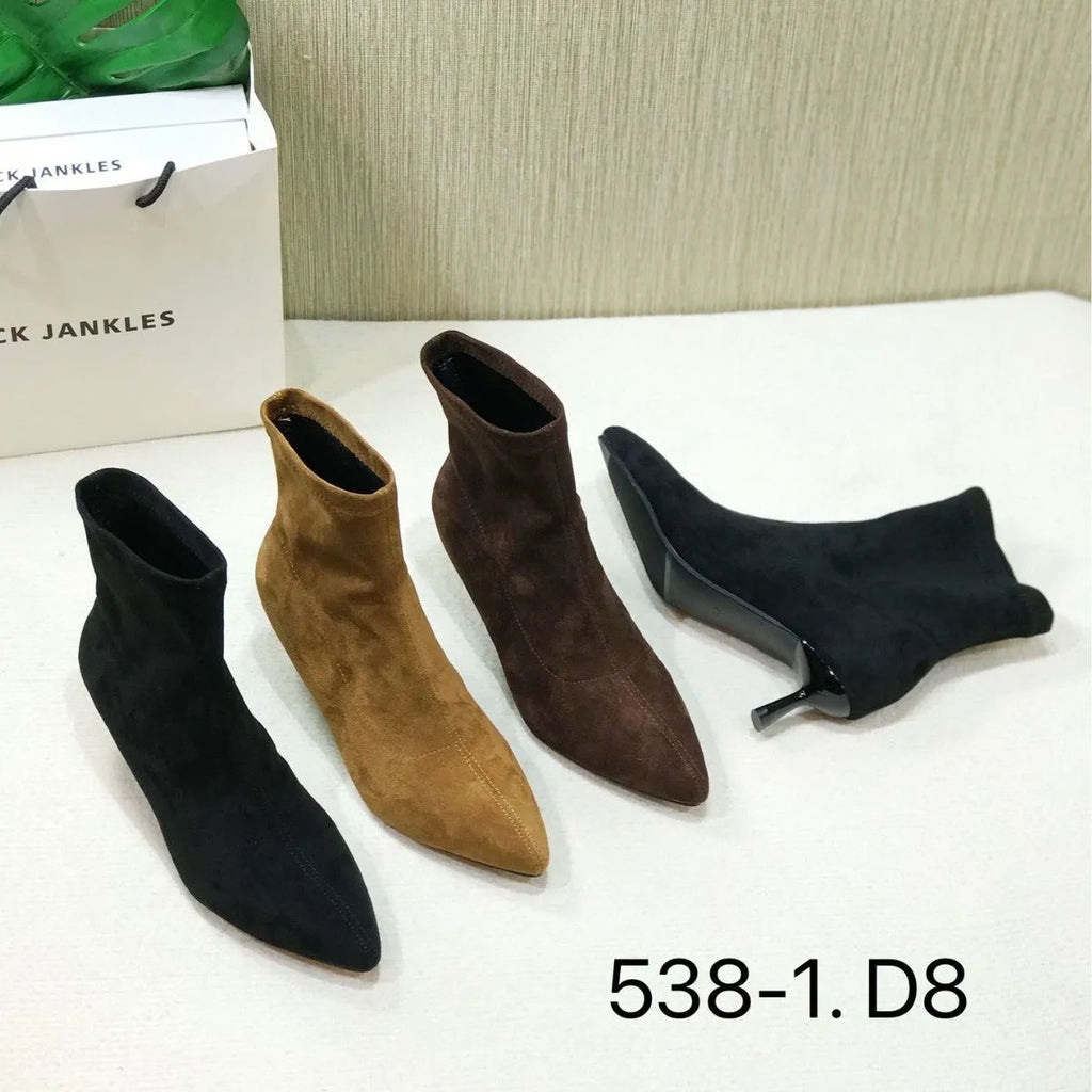 Black pointed toe women's ankle boots with a stiletto heel on a neutral background.