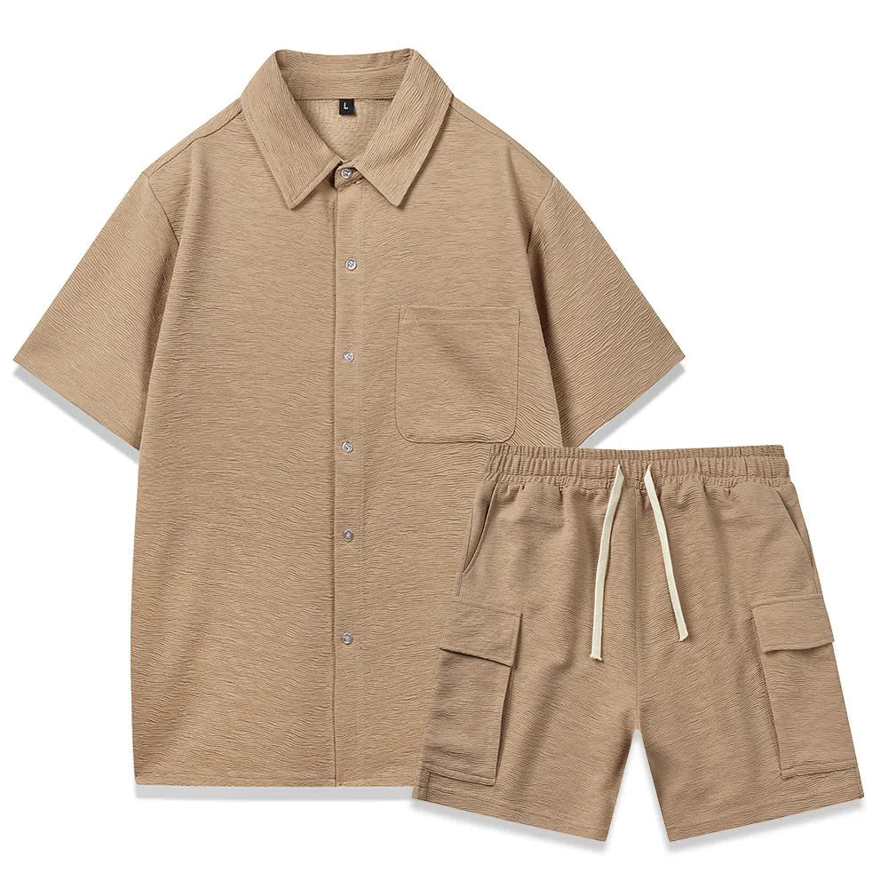 Women's black polyester two-piece set with short sleeve top and elastic waist shorts laid flat.