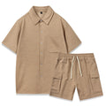 Women's black polyester two-piece set with short sleeve top and elastic waist shorts laid flat.