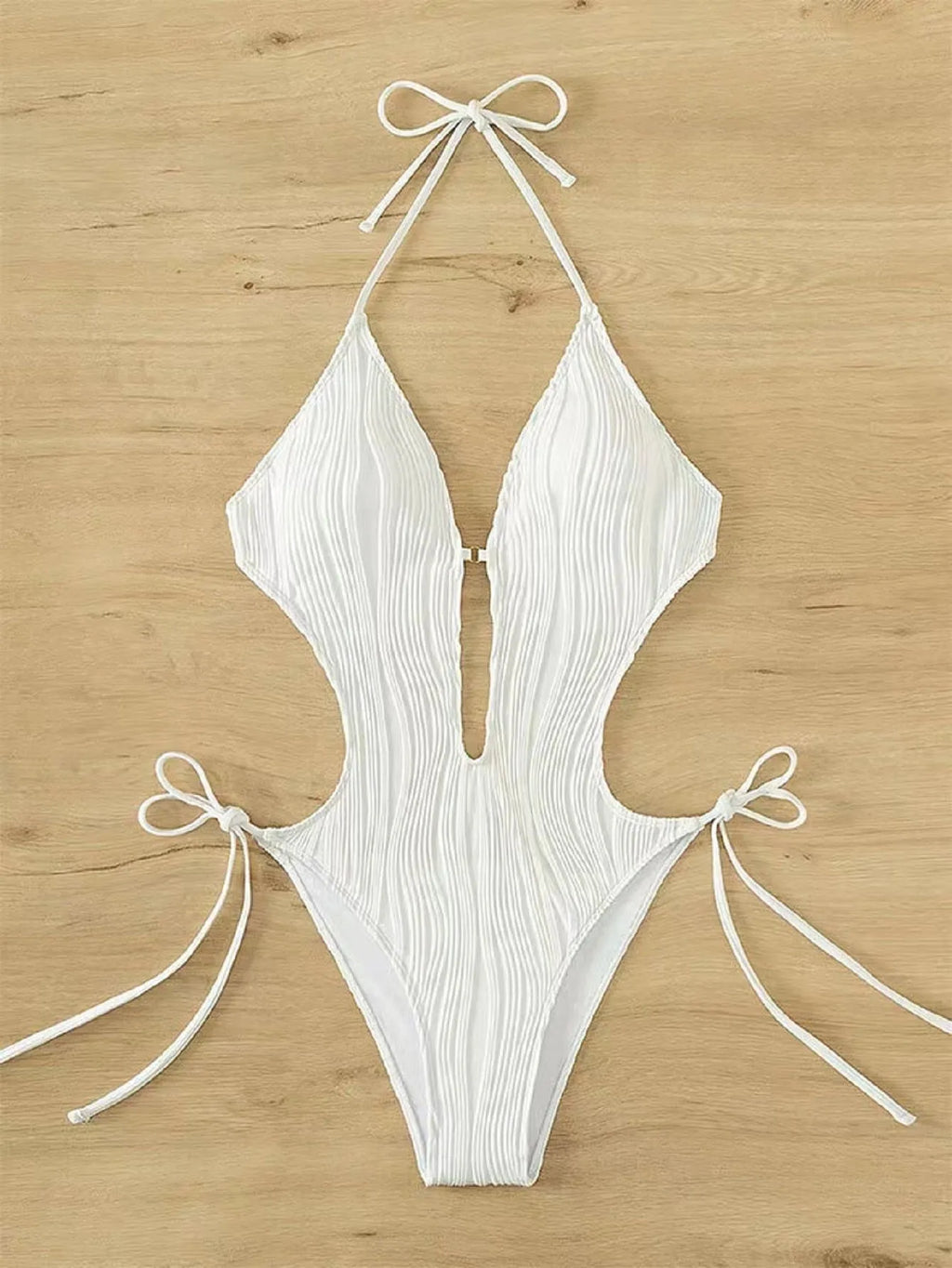 Women's black lace-up triangle bikini swimsuit on hanger showing adjustable ties and solid colour polyester fabric