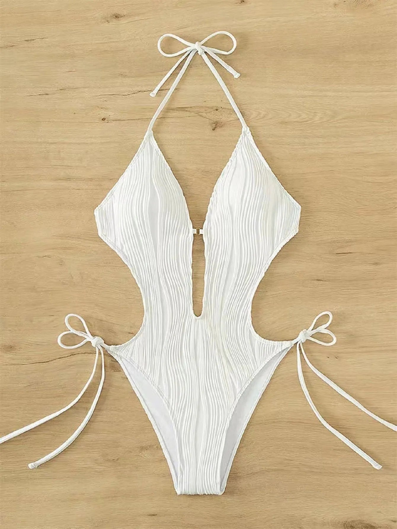 Women's black lace-up triangle bikini swimsuit on hanger showing adjustable ties and solid colour polyester fabric