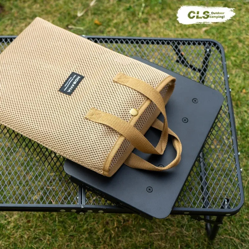 CLS Outdoor aluminium folding camping stool with PU cushion next to its bag that converts into a small table.