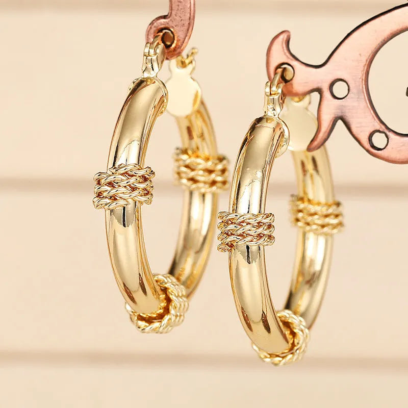 Geometric copper earrings with ring and line design in a gold colour.