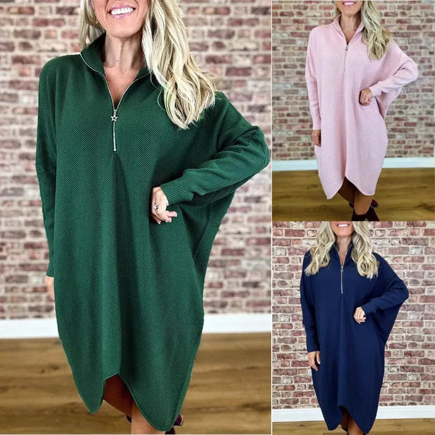 Women's loose-fit knitted dress in navy blue with a front zip closure and raglan sleeves.