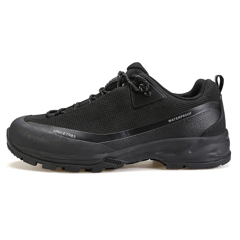 Men's low-top hiking boots in black with a leather mesh upper and rugged rubber outsole.