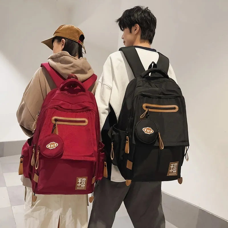 Large black nylon school backpack with curved shoulder straps for secondary school students.
