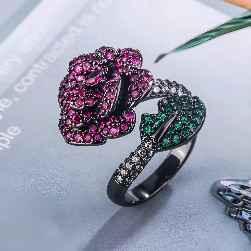 Geometric black gold flower ring with simulation red corundum centrepiece on female hand