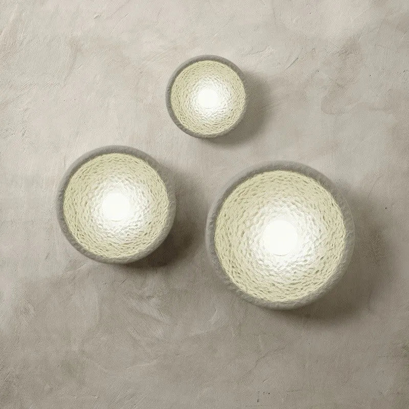 Japanese-style wall lamp with resin shade in three diameter sizes on white wall