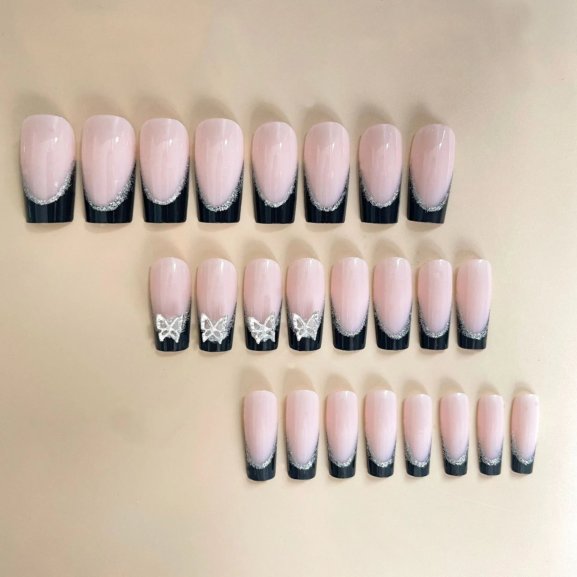 Black French style false nails with butterfly pattern and glittering finish, medium length