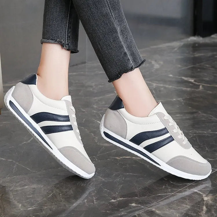 Blue low top lace-up sneaker with soft rubber sole and PU mesh upper