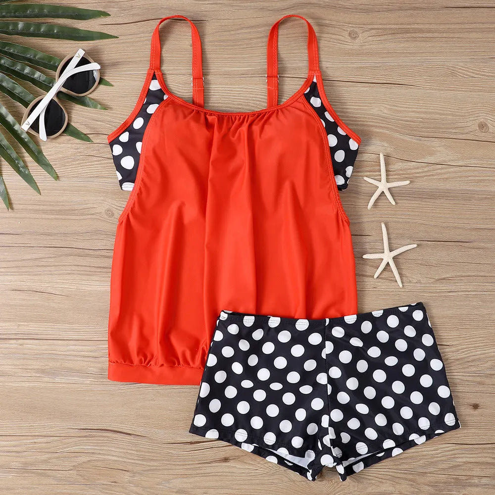 Black women's polka dot swimsuit with high-waist boxer brief bottoms.