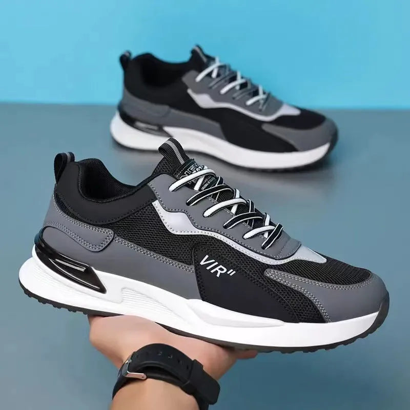 Men's colour block mesh running sneakers in black, grey, and white on a plain background.