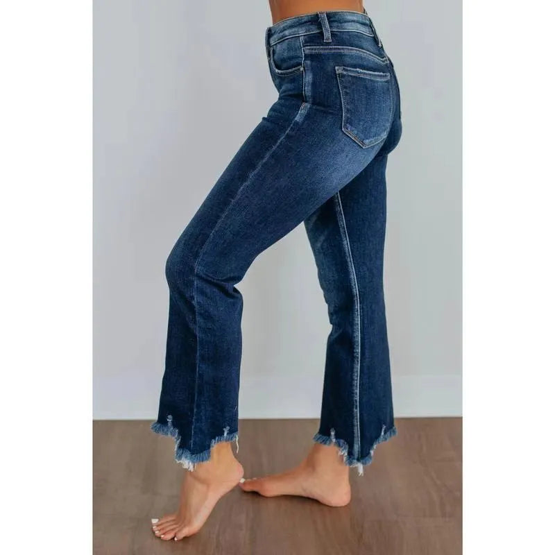Women's solid colour denim jeans on a hanger showing hand-worn texture and available in dark blue and light blue