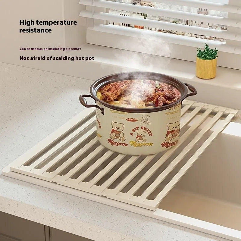 Foldable milky white stainless steel kitchen draining rack inside a sink