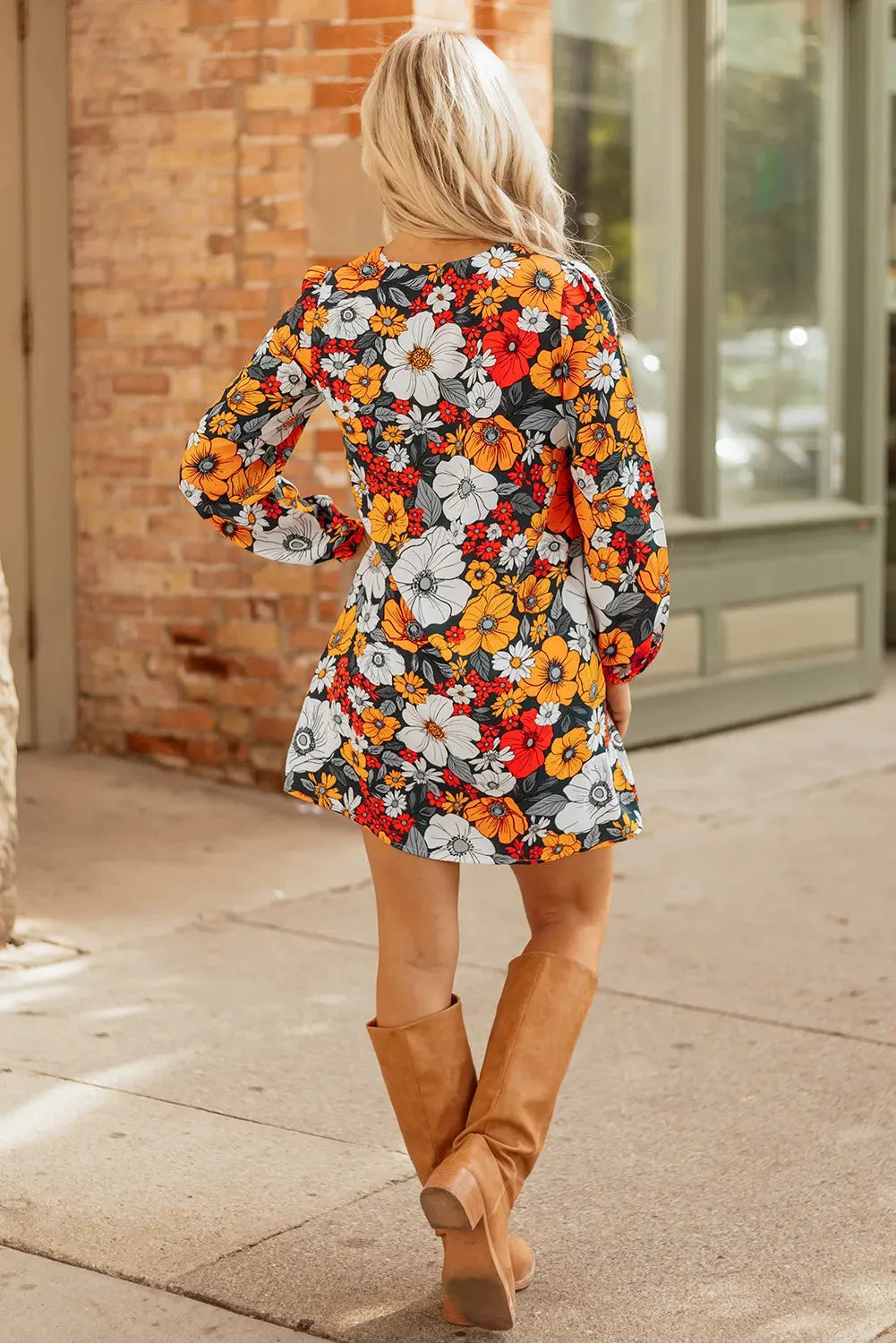 Orange floral print women's mini dress with striped lace trim, V-neck, and long sleeves.
