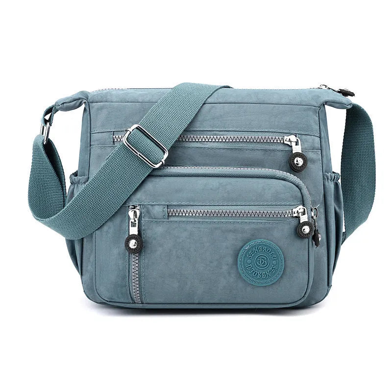 Nylon messenger bag in square vertical shape with single shoulder strap, shown in one of five colour options