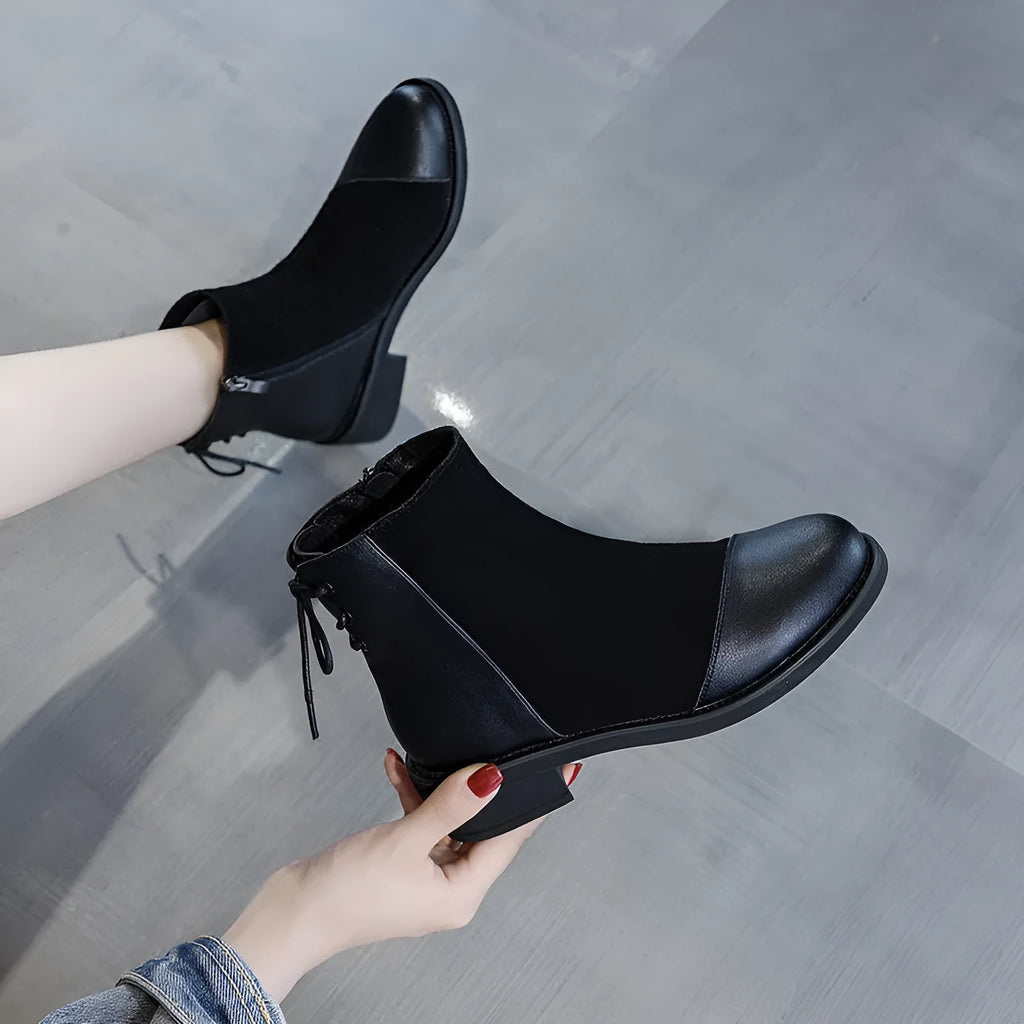 Women's black knee-high Martin boots with side zip closure and bow detailing