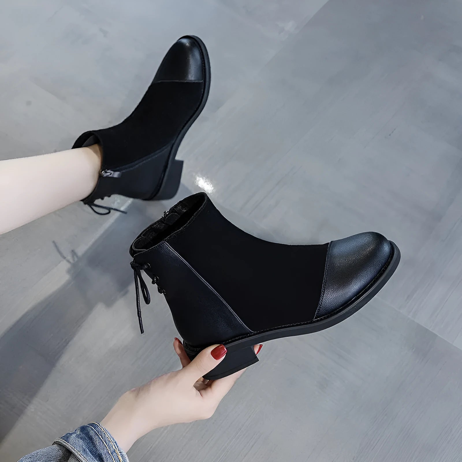 Women's black knee-high Martin boots with side zip closure and bow detailing