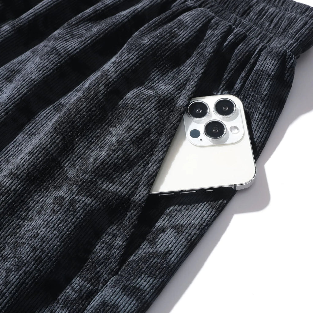 Men's camouflage pattern corduroy shorts with an elasticated high waistband on a plain background.