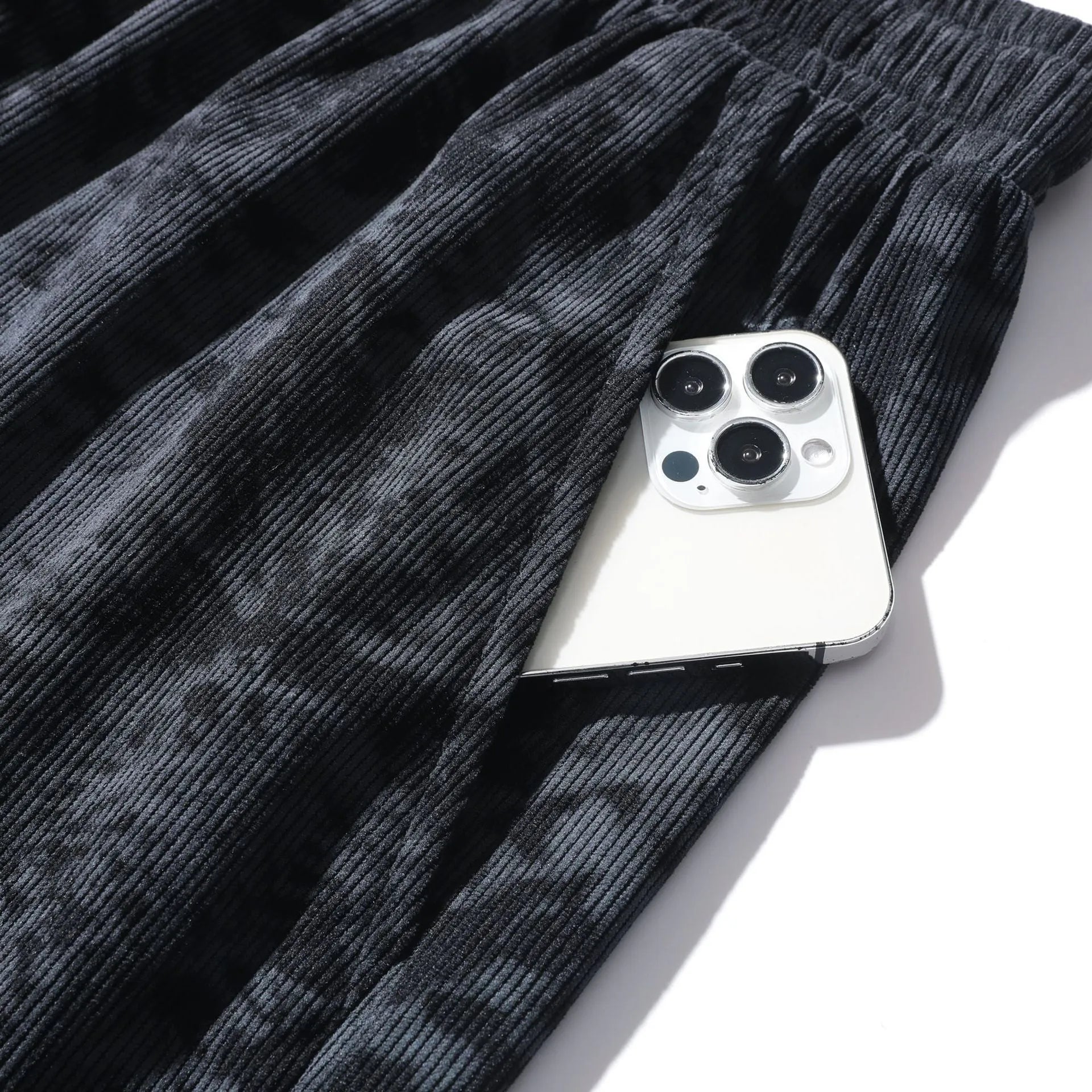 Men's camouflage pattern corduroy shorts with an elasticated high waistband on a plain background.