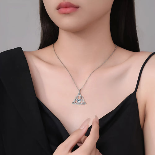 Close-up of a women's Celtic knot pendant necklace with geometric design in a choice of blue, lvzuan, red diamond or white diamond colour.